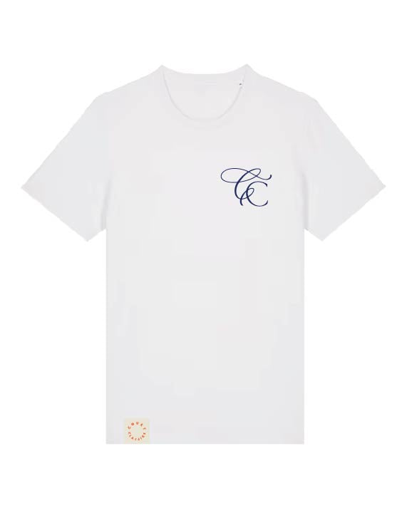A white short-sleeve crewneck t-shirt with a navy blue cursive monogram logo on the left chest and a small peach-colored circular patch near the bottom left hem, shown on a plain white background.